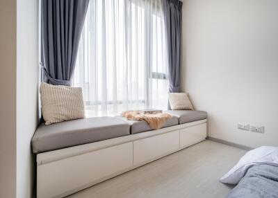 cozy window seating area in a bedroom with cushions and natural light