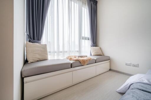 cozy window seating area in a bedroom with cushions and natural light