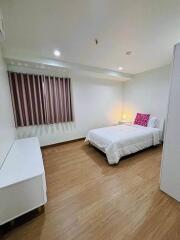 Bedroom with bed, nightstand, lamp, curtains, and white dresser