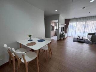 Open dining and living area with wooden floors