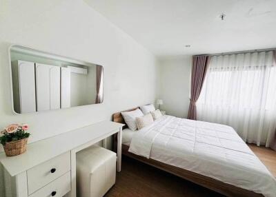 Spacious bedroom with a double bed, bedside table, and dressing table