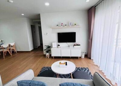 Modern living room with natural light and wooden flooring