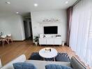 Modern living room with natural light and wooden flooring