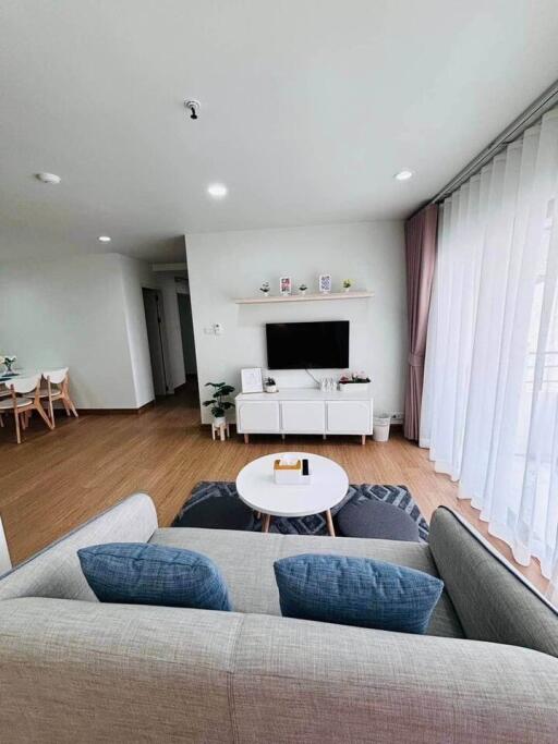 Modern living room with natural light and wooden flooring