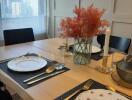 Dining area with table set for a meal, featuring views of cityscape