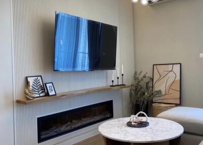 Modern living room with wall-mounted TV and marble coffee table