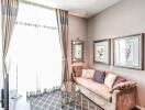 Bright and cozy living room with a sofa, wall art, and a glass table.