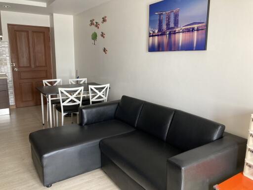 Living room with black leather sofa and dining table