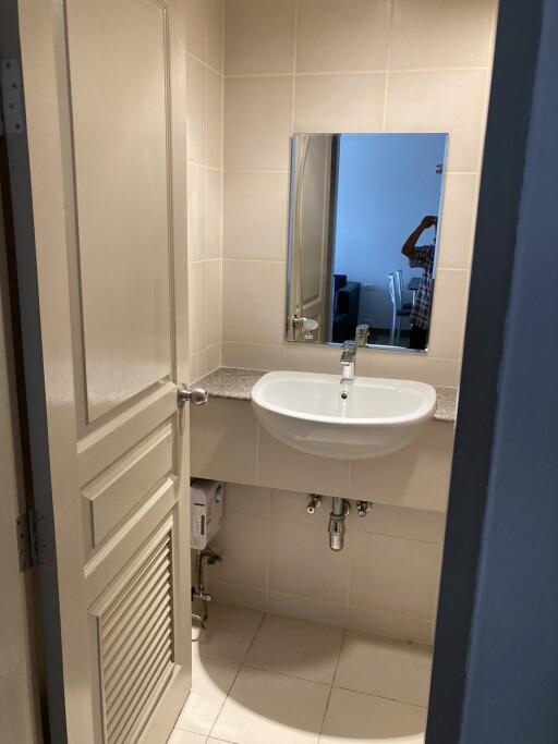 Compact bathroom with a sink and mirror