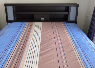 Bed with striped bedding and headboard