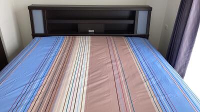 Bed with striped bedding and headboard