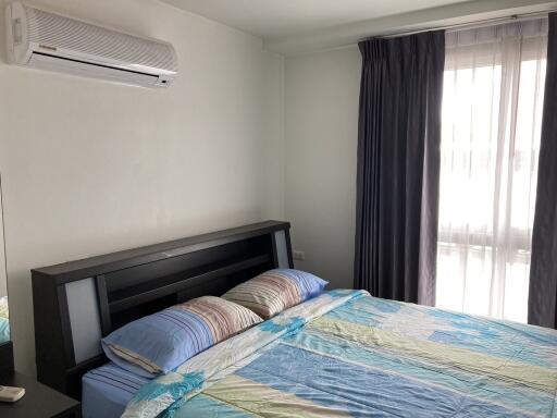 Modern bedroom with air conditioner and large window