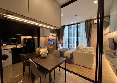 Modern studio apartment with integrated kitchen, dining and living areas