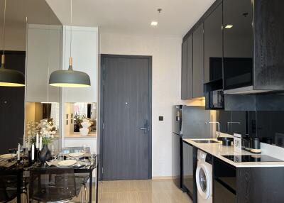 Modern kitchen area with dining table and appliances