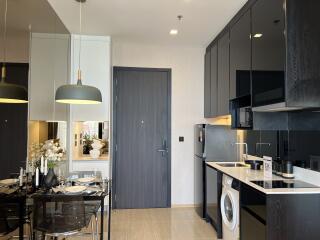 Modern kitchen area with dining table and appliances