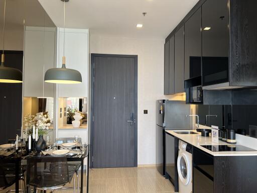 Modern kitchen area with dining table and appliances