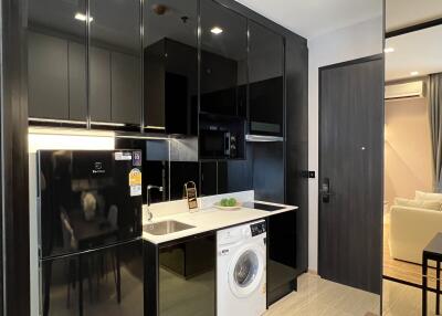 Modern kitchen with black cabinets and built-in appliances