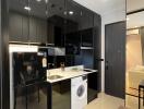 Modern kitchen with black cabinets and built-in appliances