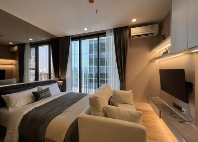 Modern bedroom with large windows and city view