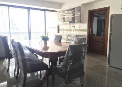 Dining area with large windows and wrapped furniture