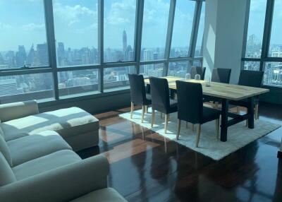 Modern living room with dining area and city view