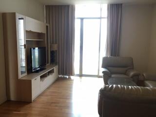 Living room with wooden flooring, entertainment center, and leather seating