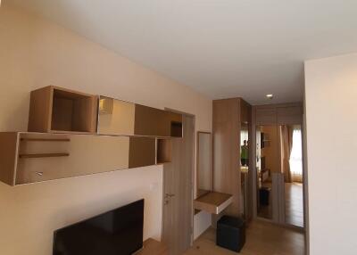 Modern living room with wooden furniture and wall-mounted shelving