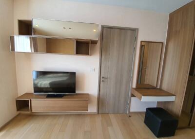 Modern bedroom with TV and wooden furniture