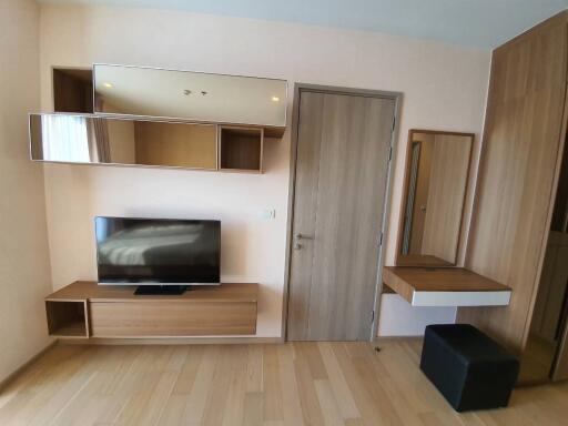 Modern bedroom with TV and wooden furniture