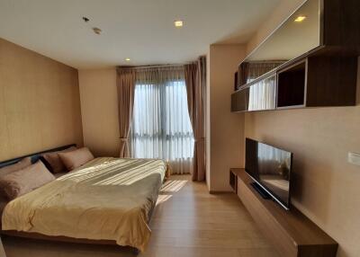 Spacious bedroom with a double bed and wall-mounted TV