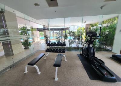 Modern gym with equipment and view of the pool area