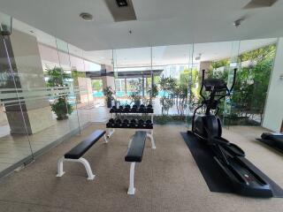 Modern gym with equipment and view of the pool area