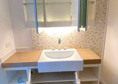 Modern bathroom with vanity, mirror, and storage