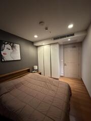 Modern bedroom with artwork and soft lighting