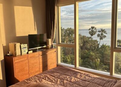 Bedroom with large window and scenic view