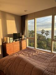 Bedroom with large window and scenic view