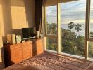 Bedroom with large window and scenic view