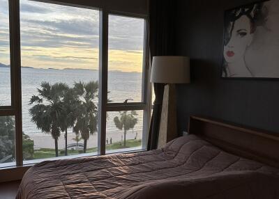 Bedroom with large window and ocean view