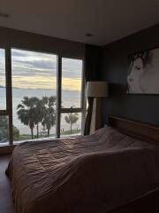 Bedroom with large window and ocean view