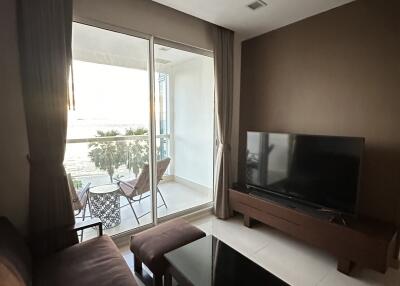 Cozy living room with glass door leading to a balcony