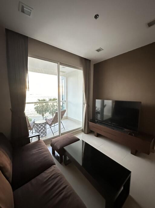 Cozy living room with glass door leading to a balcony