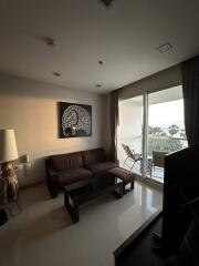 Well-lit living room with a sofa and wall art