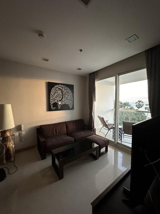 Well-lit living room with a sofa and wall art