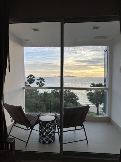 Balcony with a view of the ocean at sunset