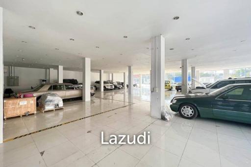 Prime Corner Showroom for Car Dealership or Business with Heavy-Duty Lift and Ample Parking