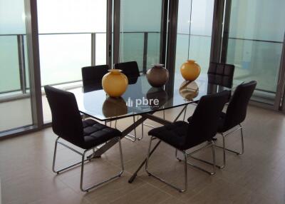 Modern dining area with glass table and six chairs