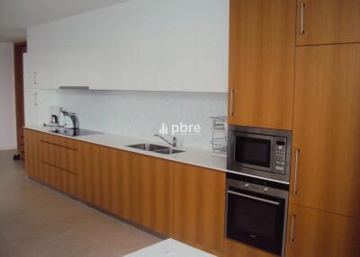 Modern kitchen with wooden cabinets and stainless steel appliances