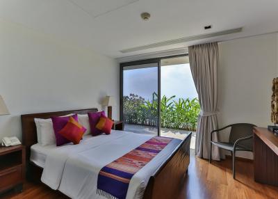 Spacious bedroom with balcony access